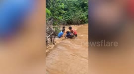 Locals retrieve scooter swept away by muddy torrents