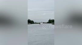 Drag boat engine catches fire during canal drag race in Thailand