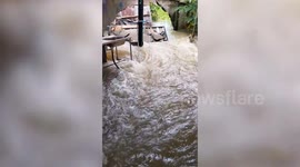 Surging flash floods gush through homes in Thailand