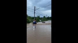 Locals play around in floods outside their home in Thailand