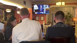 Lobbyists gather around TV in Dublin hotel, Ireland as budget is unveiled
