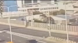 Car dangles in space between two bridges parallel to each other following crash