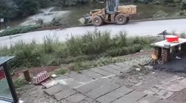 Digger crashes into lake when brakes fail as locals rescue driver from water
