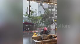 Quick-thinking pedestrian stops metal barrier from rolling into car during storm