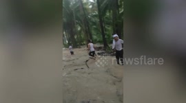 Pupils rescue motorcycle from raging floods sweeping through village