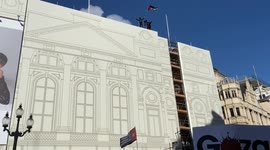 Pro-Palestine protesters climb on top of a building with scaffolding in Piccadilly Circus