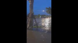 Hundreds of people moved through floodwaters to a safe area as floodwaters rose in Vietnam