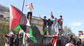 Palestine supporters arrive at Trafalgar Square during protest march through London