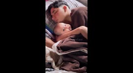 Sleeping Dad Cuddles Infant Daughter
