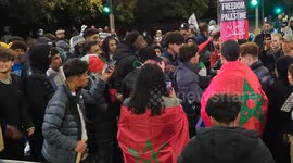 Pro-Palestine protesters attempt to burn an Israel flag close to the Israeli Embassy