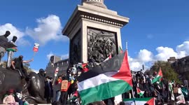 Palestine supporters rally around the Nelsons Column in Trafalgar Square during London march