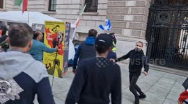 Pro-Palestinians protesters attempt to run away with Israeli flag in London and call Iranian dissident 'a terrorist'