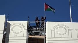Flag of Palestine raised on the roof of Trocadero London with march in support of Palestine at Piccadilly Circus
