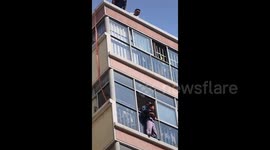Chinese engineers' heroic descent to save boy trapped outside fourth-floor window