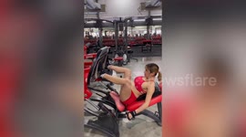 Super-fit pregnant mum does squats while weightlifting at gym in Bangkok