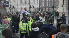 Pro-Palestinian supporters follow police officers arresting a protester and attempt to block a police van from leaving