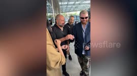 Sam Smith signs Korean fan's arm during his Asia tour