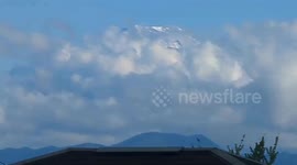Snow-capped Mt. Fuji emerges after rain: a time-lapse view