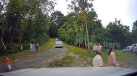 Overloaded truck full of Buddhist monks rolls backwards into ditch injuring youngsters