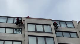 Protesters scale hotel in London and drop a banner during a major oil summit