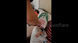 Toddler with head stuck in bin nods off awaiting rescue