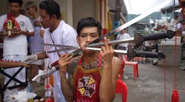 Devotees have cheeks pierced with swords and knives at Phuket Vegetarian Festival