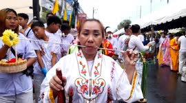 Devotees pierce their faces with skewers at Phuket Vegetarian Festival