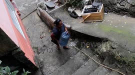 A great woman in the city of Padang carries water while walking uphill 500 meters to meet the need for a clean water supply in her home