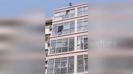 Workers rescue boy, 6, stranded on fifth-floor window ledge in China