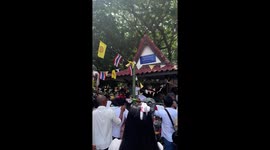 Frenzied Thai locals jostle to grab ritual food offerings at annual Buddhist festival to honour the dead