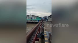 Huge ice blocks whizz along flume at factory in Thailand
