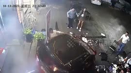 Distracted driver reverses into diners in China