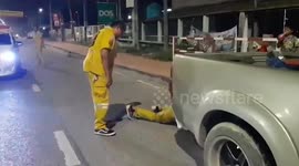 Rescue volunteers pull out large python from truck's fender