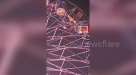 Fire officials rescue trapped people on giant wheel at fair in northern India