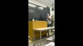 Energetic Foreign Teacher Interacts with Student Napping at the Podium in China