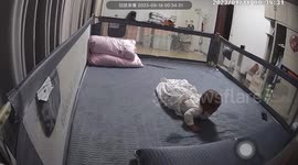Baby seen on monitor playing with dad's mobile phone