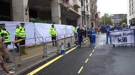 Climate activists dressed as doctors demonstrate outside Energy Intelligence Forum in Central London