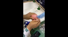 Doll Gets Blue Hair Sewn On