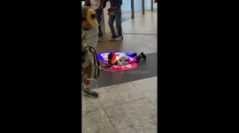 Toddler fascinated by lights on shopping mall floor