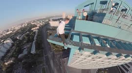 Daredevil Makes Precarious Dash Across  High-Rise Rooftop