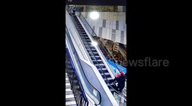 Quick-thinking security officer saves woman from escalator tumble in China