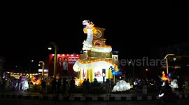 Visitors pose with colorful light decorations at Phuket Vegetarian Festival