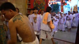 Devotees possessed by spirits before face mutilations with skewers at Phuket Vegetarian Festival