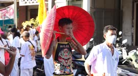 Locals pierce their cheeks with swords, skewers and even umbrellas before firecracker parade