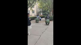 Students in T-Rex dinosaur suits terrify children on university campus