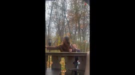 Woman taken by joyful surprise as tranquil Champagne toast turns into a wedding proposal