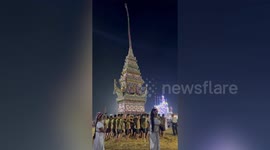 Devotees sway extraordinary homemade shrine at Buddhist festival in Thailand