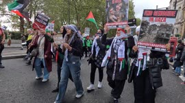 Pro-Palestinian woman march in central London with flags and placards chanting
