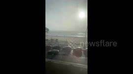 Spain: Pedestrian Struggles To Walk Against High Winds Amid Storm Bernard