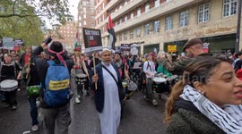 Pro-Palestinian protesters drumming in central London with flags and placards against Israeli strikes on Gaza